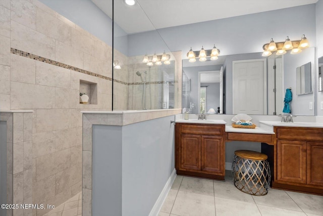 bathroom with tiled shower, vanity, and tile patterned floors