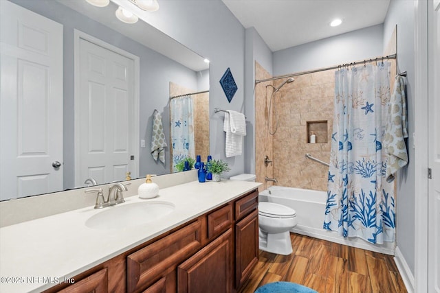 full bathroom with vanity, hardwood / wood-style flooring, toilet, and shower / bath combo