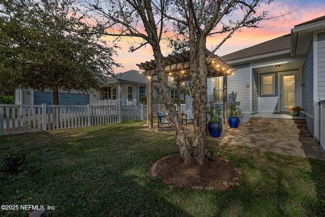 yard at dusk with a patio area