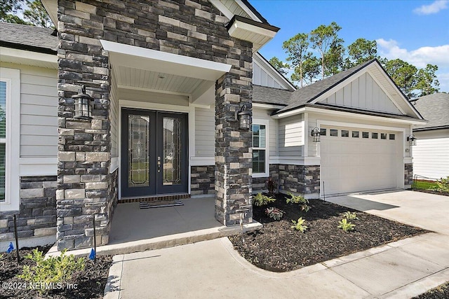 property entrance featuring a garage and french doors