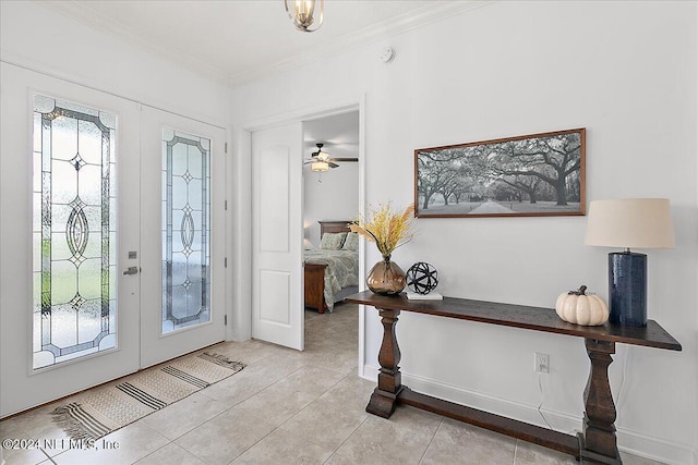 tiled foyer featuring french doors and ornamental molding