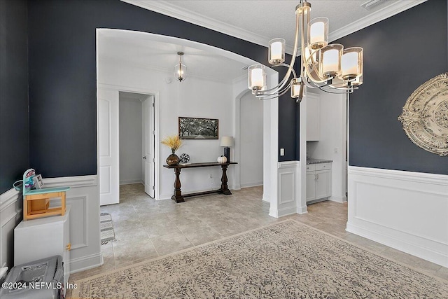 dining space with ornamental molding, a chandelier, a textured ceiling, and light tile patterned floors