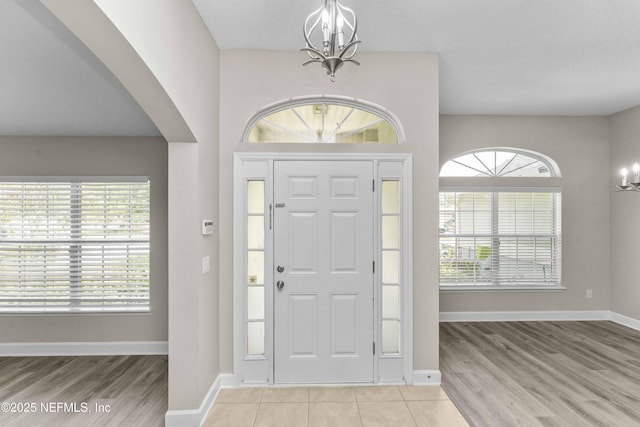 entrance foyer featuring an inviting chandelier and light hardwood / wood-style floors