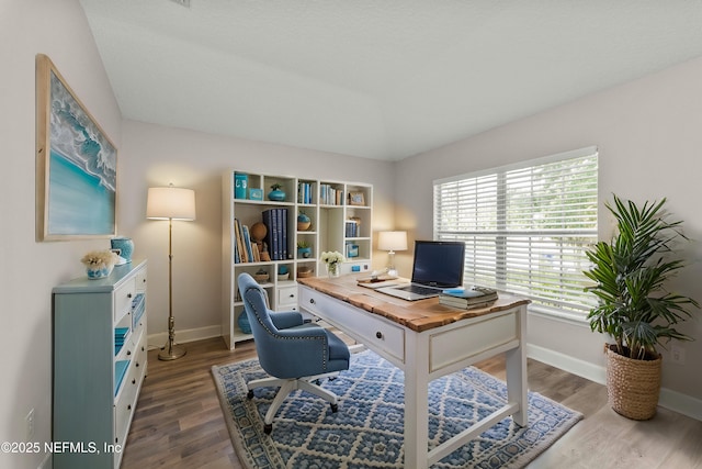 office space with vaulted ceiling and hardwood / wood-style floors