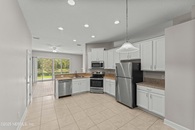 kitchen with white cabinetry, sink, pendant lighting, and stainless steel appliances