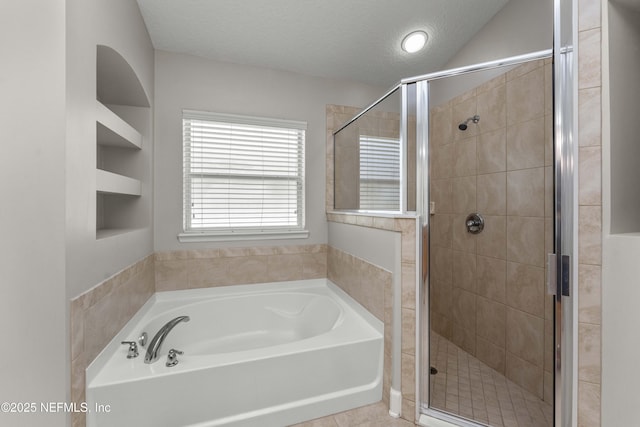 bathroom featuring independent shower and bath and a textured ceiling