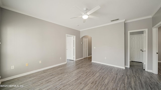 unfurnished bedroom featuring dark hardwood / wood-style flooring, ornamental molding, and ceiling fan