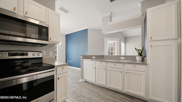 kitchen featuring white cabinetry, ornamental molding, stainless steel appliances, and light stone counters