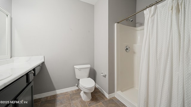 bathroom featuring vanity, curtained shower, and toilet