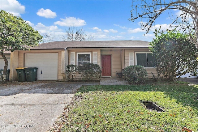 single story home featuring a garage and a front yard