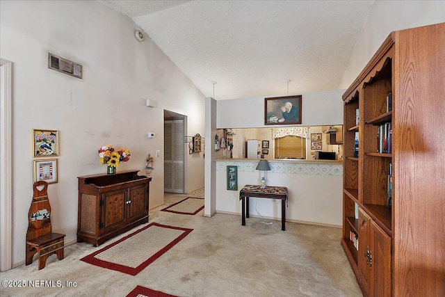 interior space featuring light colored carpet and high vaulted ceiling