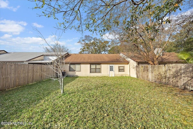 rear view of house with a lawn