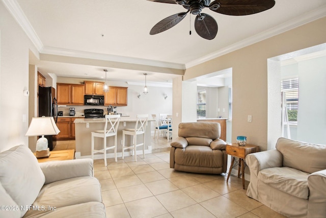 tiled living room with crown molding and ceiling fan