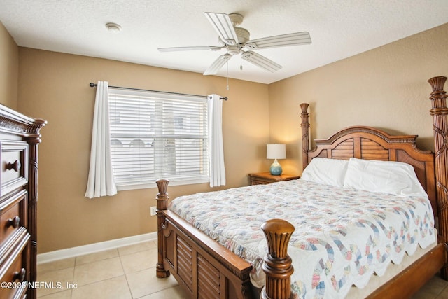 tiled bedroom featuring ceiling fan and a textured ceiling