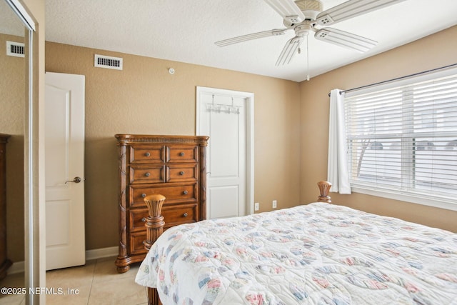 tiled bedroom with ceiling fan