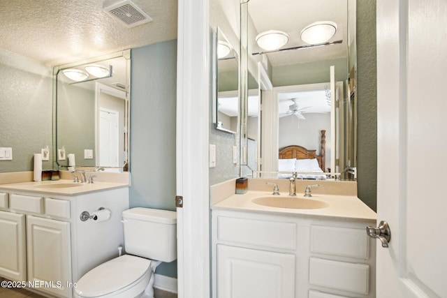 bathroom with vanity, ceiling fan, and toilet