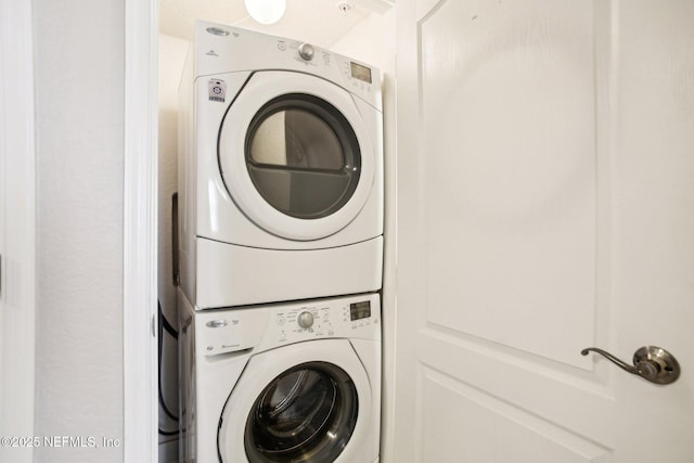 laundry area with stacked washer and clothes dryer