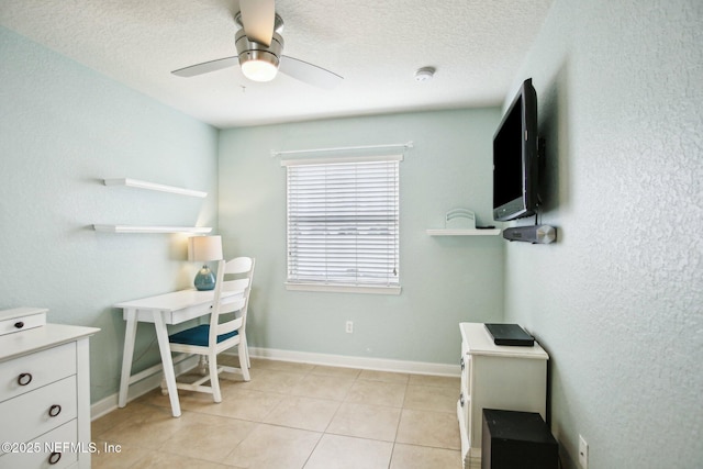 tiled office featuring a textured ceiling and ceiling fan