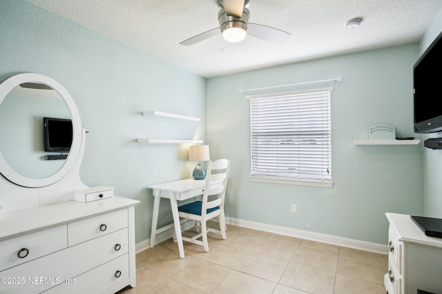 tiled office with ceiling fan and a textured ceiling