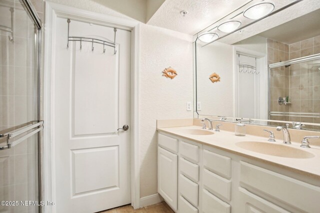 bathroom with vanity, tile patterned flooring, and walk in shower