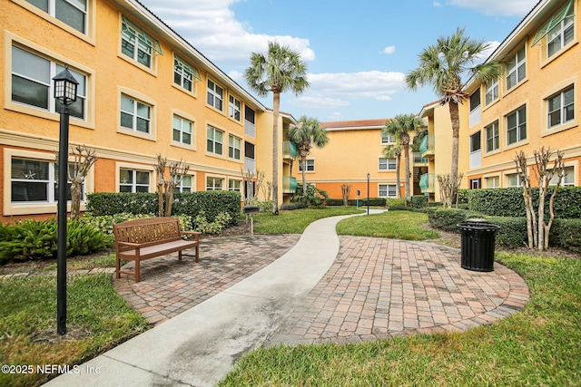 view of community with a lawn and a patio