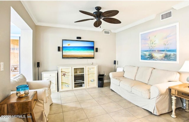 tiled living room with ornamental molding and ceiling fan