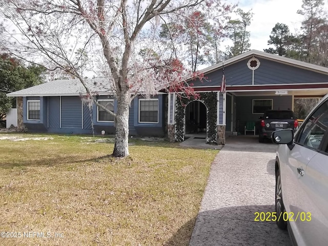 view of front of property with a carport and a front lawn