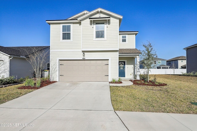 traditional home featuring an attached garage, fence, concrete driveway, and a front yard