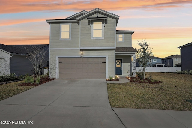 traditional home with driveway, a garage, fence, and a front lawn