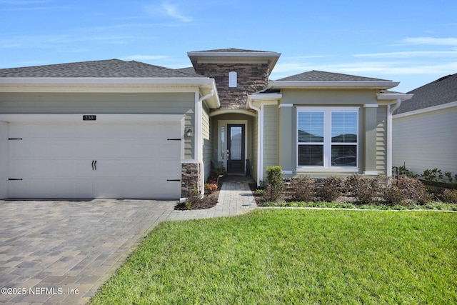 prairie-style house featuring a garage and a front lawn