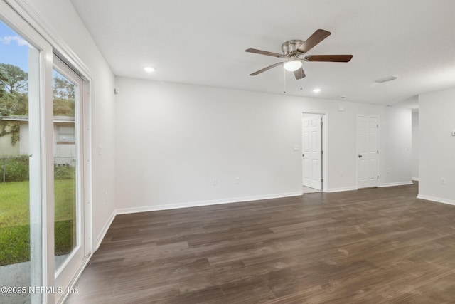 empty room featuring dark wood-type flooring and ceiling fan