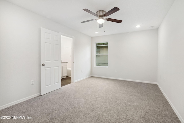 carpeted spare room with ceiling fan