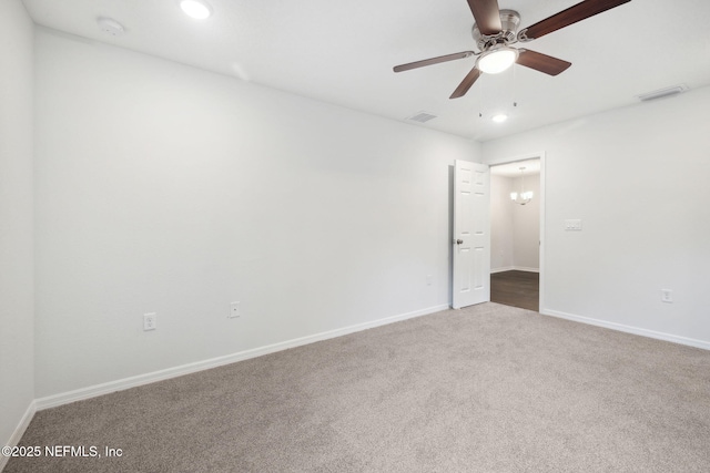 empty room featuring ceiling fan and carpet