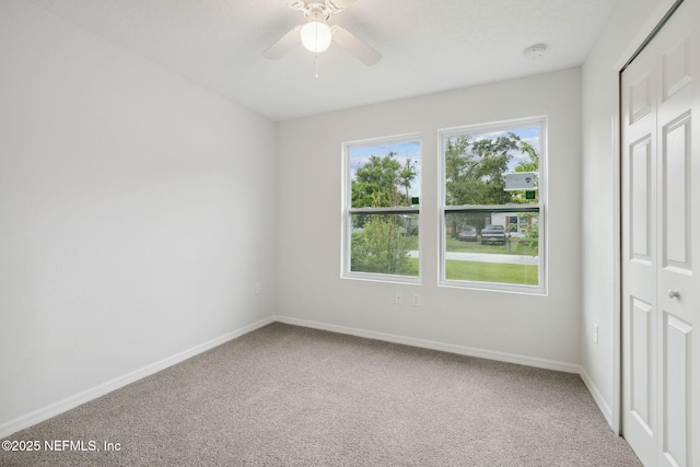 unfurnished bedroom with carpet floors, a closet, and ceiling fan