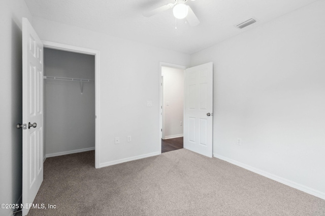 unfurnished bedroom with ceiling fan, carpet flooring, and a closet