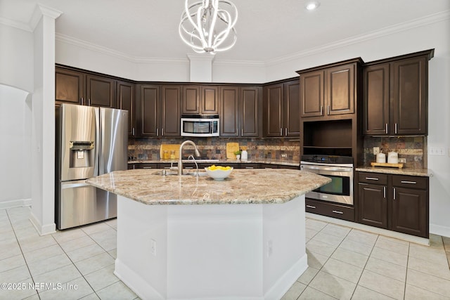 kitchen with light tile patterned floors, appliances with stainless steel finishes, and dark brown cabinetry