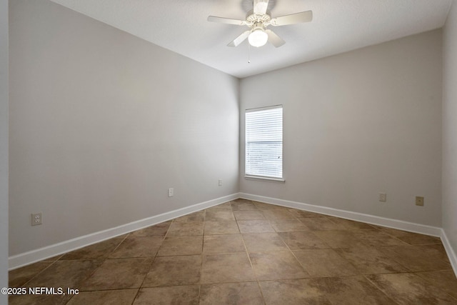 empty room with ceiling fan, baseboards, and tile patterned flooring