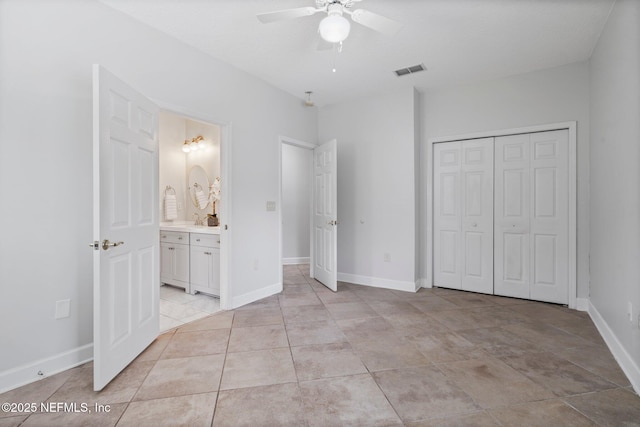 unfurnished bedroom with a ceiling fan, a closet, visible vents, and baseboards