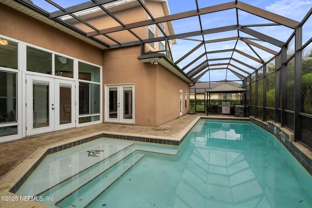 outdoor pool featuring french doors, area for grilling, a patio, glass enclosure, and a gazebo