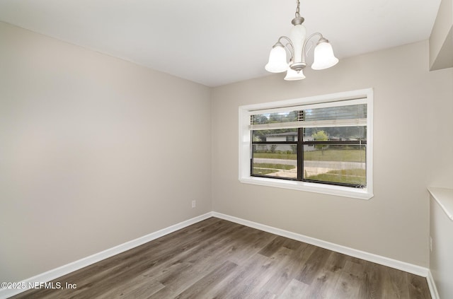 unfurnished dining area featuring an inviting chandelier and hardwood / wood-style flooring