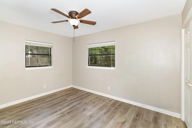 unfurnished room featuring ceiling fan, a healthy amount of sunlight, and light wood-type flooring