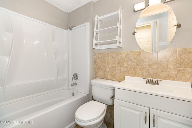 full bathroom featuring tile walls, vanity, tub / shower combination, and toilet