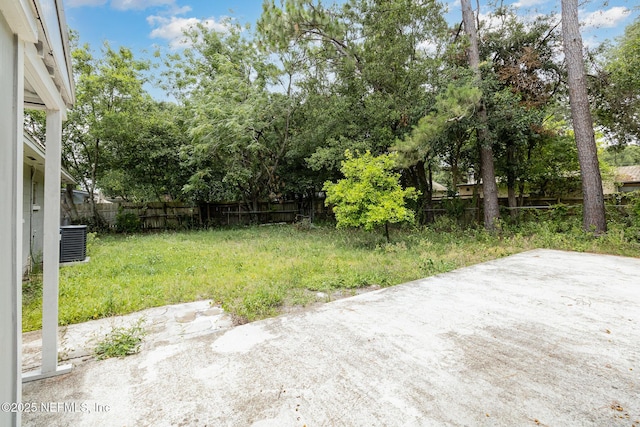 view of yard featuring cooling unit and a patio