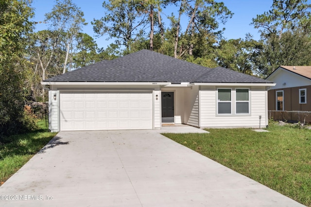 single story home featuring a garage and a front lawn