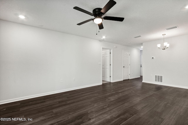 unfurnished room with ceiling fan with notable chandelier, dark hardwood / wood-style floors, and a textured ceiling