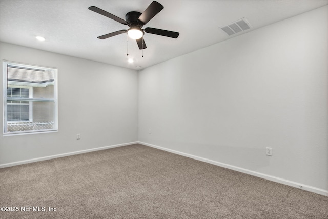 carpeted spare room with ceiling fan