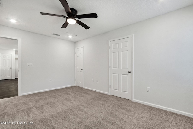 carpeted empty room featuring ceiling fan