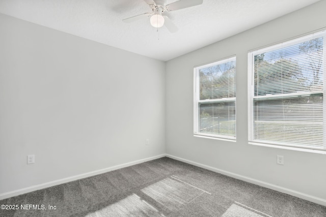 carpeted spare room featuring a textured ceiling and ceiling fan