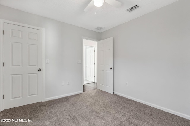 unfurnished bedroom with ceiling fan and carpet