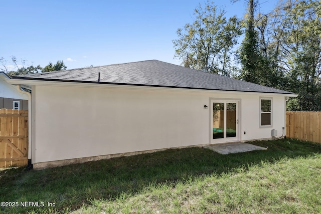 rear view of house featuring a yard